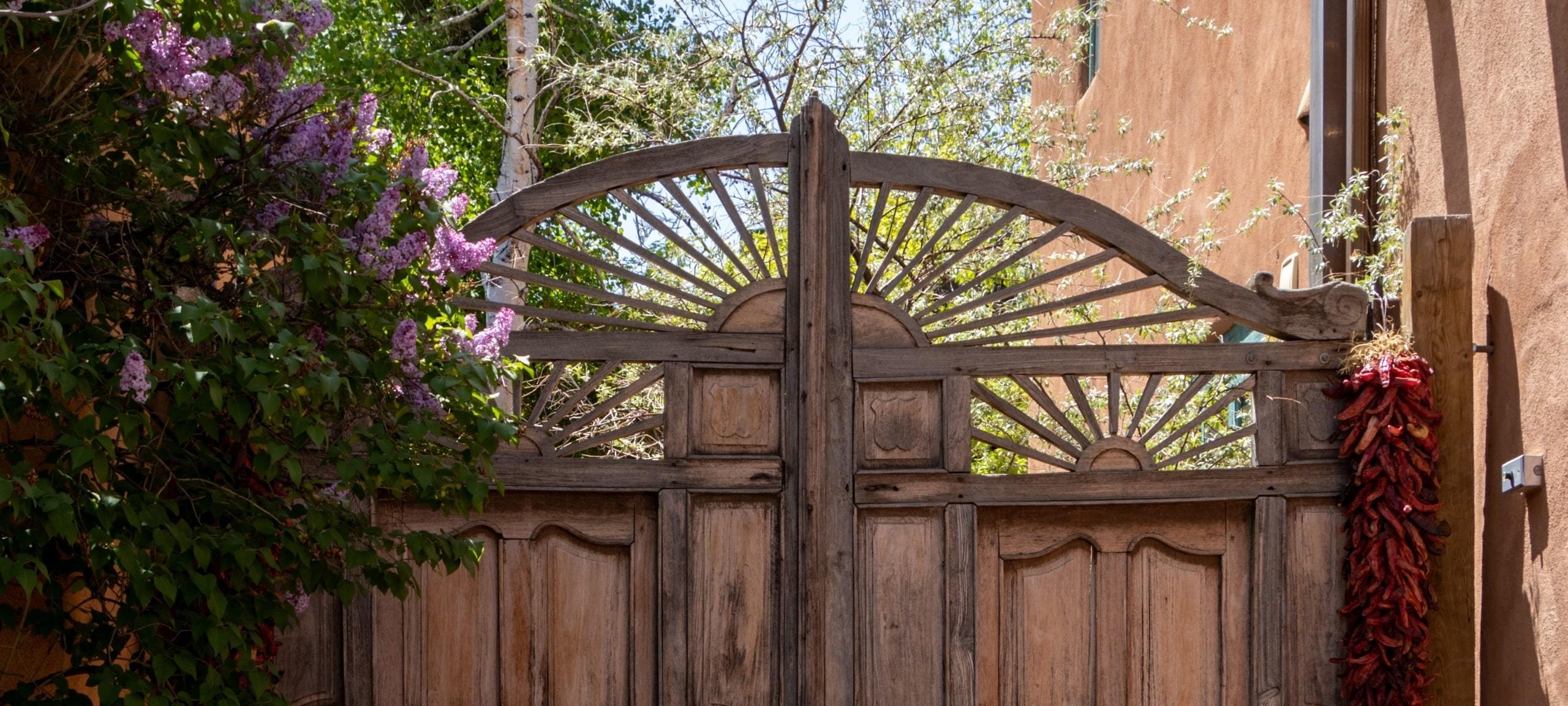 Wooden gate and flowers outside Santa Fe home